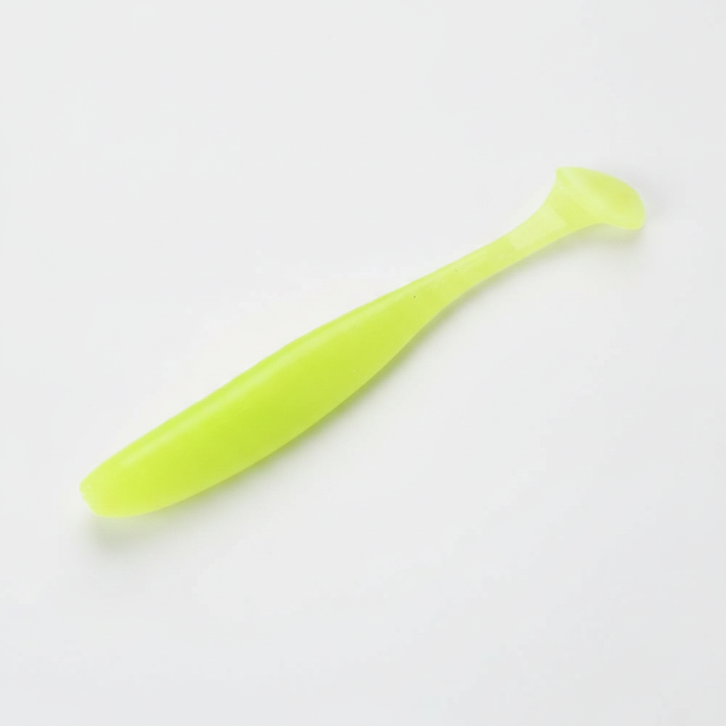Leurre souple à queue palette coloris chartreuse phosphorescent, packshot studio sur fond blanc.